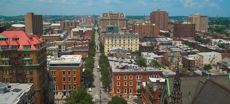 Aerial view of Baltimore city, showcasing its distinctive architecture and urban layout on a bright day.